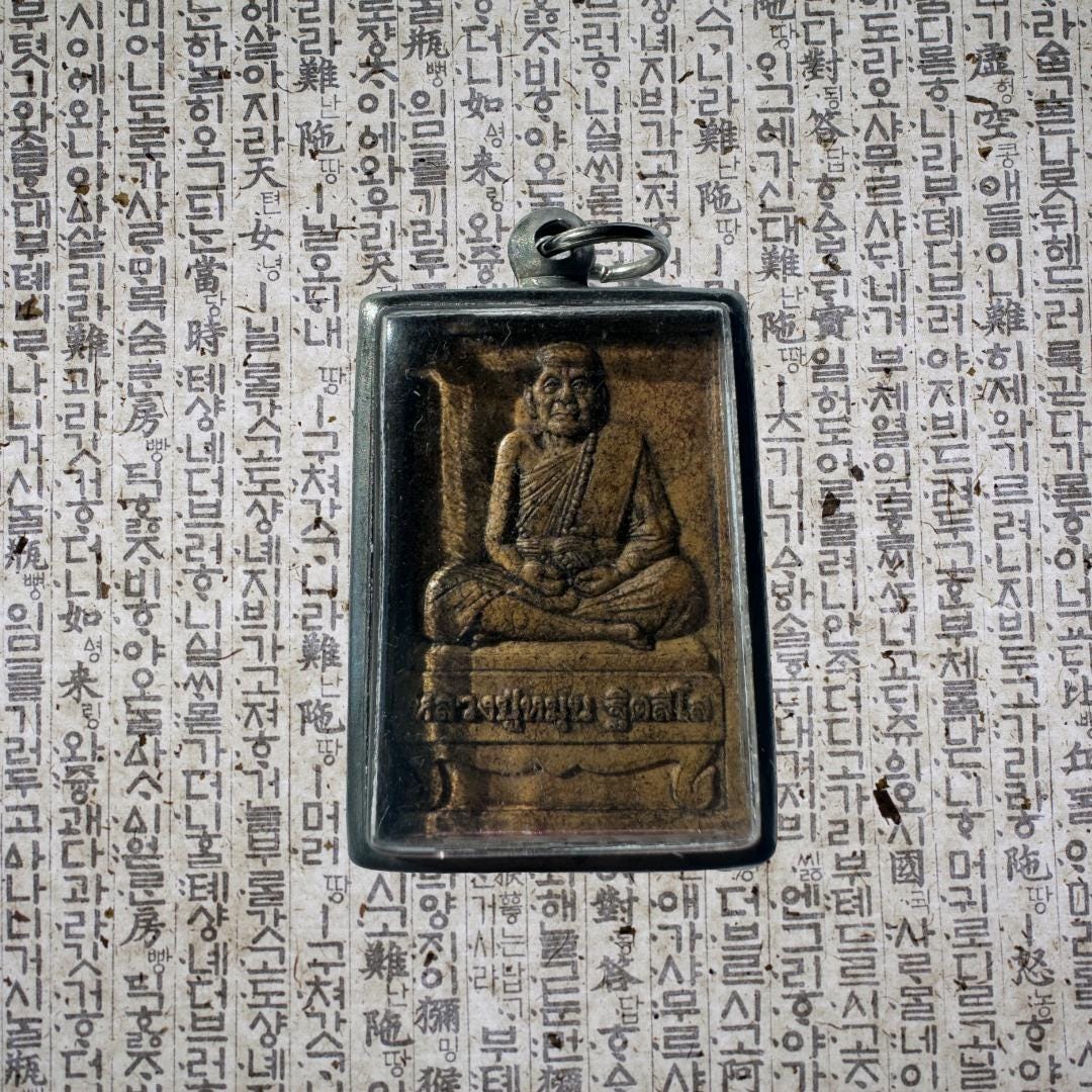 Luang Phor Tuad Amulet: Silver Case, Yantra Script | Protection and Blessings | Metta-Blessed™